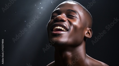 Confident black man embracing the beauty of his flawless melanin skin in studio portrait photo