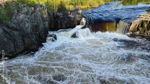 Voytsky padun waterfall in autumn. The famous powerful and wide Karelian waterfall Voytsky Padun is surrounded by rocks and greenery. Cascading waterfall on the river. Karelia, Russia 4K photo