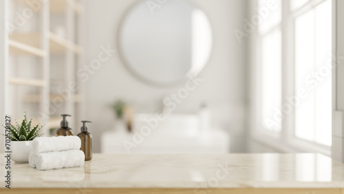 A copy space on a luxury marble tabletop with toiletries in a modern white and clean bathroom.