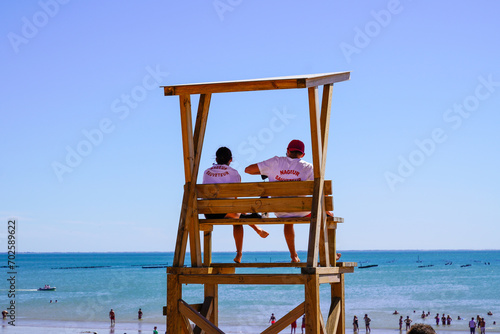 nageur sauveteur french text on shirt means man woman work  lifeguard in wooden tower on the summer sandy beach © OceanProd