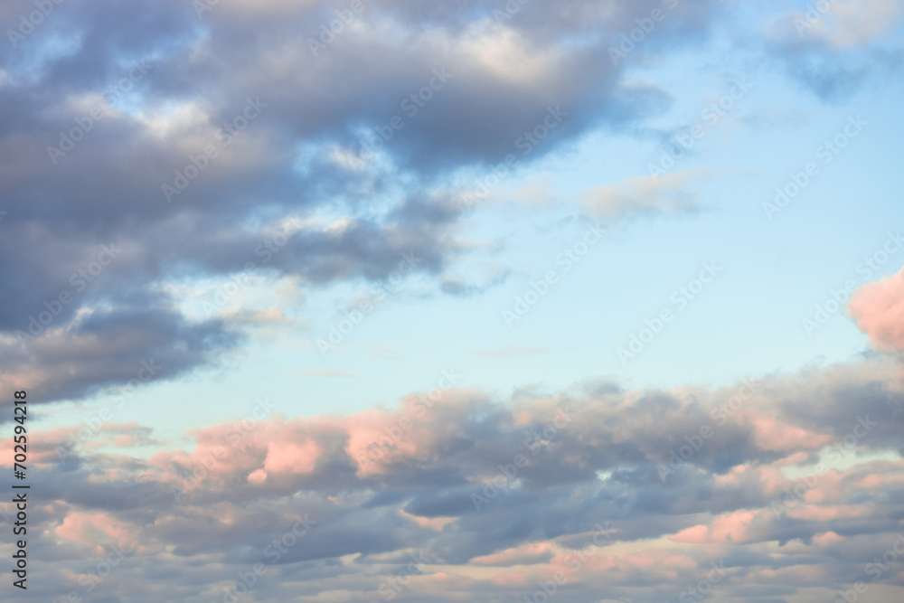 A beautiful sky tinted by the sun leaving vibrant shades of gold, pink, blue and multicolored. Clouds in the twilight evening and morning sky. Cloudy sky background in the evening and during the day. A beautiful sky tinted by the sun leaving vibrant shades of gold, pink, blue and multicolored. Clouds in the twilight evening and morning sky. Cloudy sky background in the evening and during the day.
