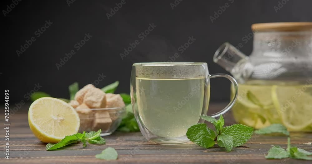 natural organic herbal tea with lemon and mint in glass teapot on a wooden table natural organic herbal tea with lemon and mint in glass teapot on a wooden table