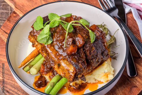 Red wine braised short ribs with grilled carrot and green vegetables