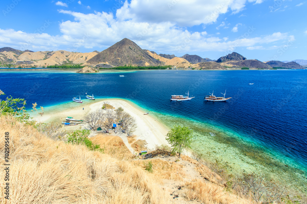 Panorama view of beaches and tourist boat sailing in Kelor Island, Flores Island, Indonesia