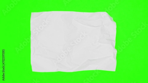 Blank sheet of white paper appears on green screen chroma key background from a paper ball, wrinkles again and disappears. Stop motion animation. 