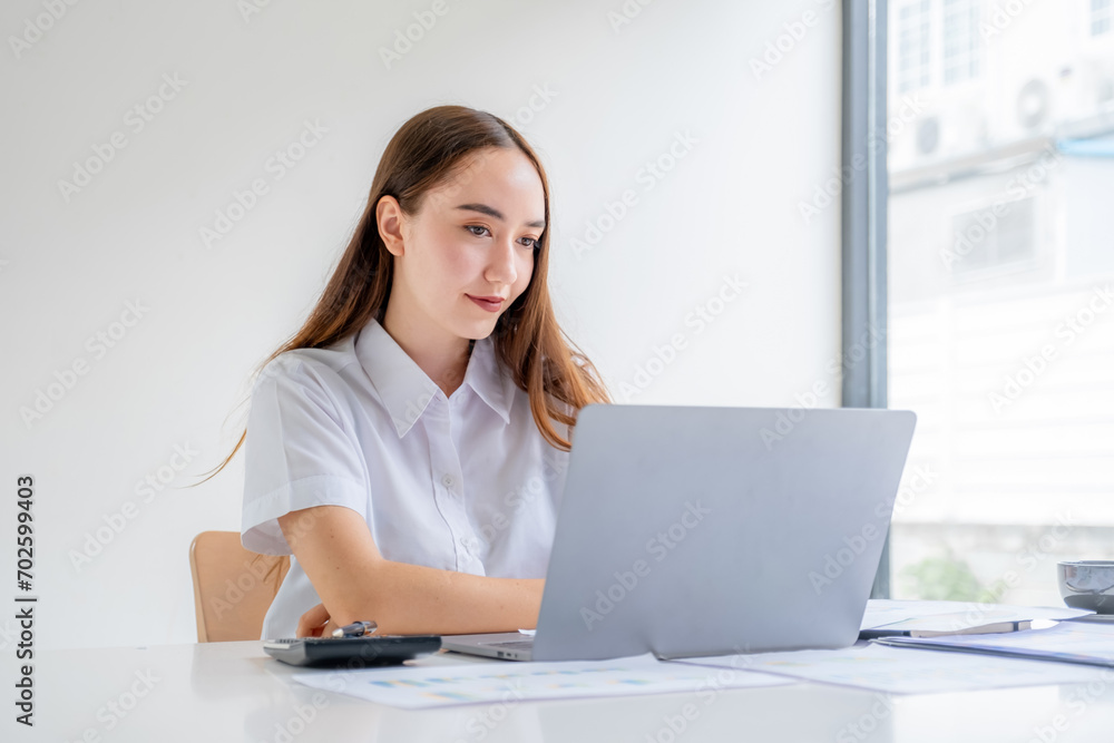 Businesswomen bookkeeper hand use laptop analysis the graph for Setting challenging business goals and ready to achieve target at home office Businesswomen bookkeeper hand use laptop analysis the graph for Setting challenging business goals and ready to achieve target at home office