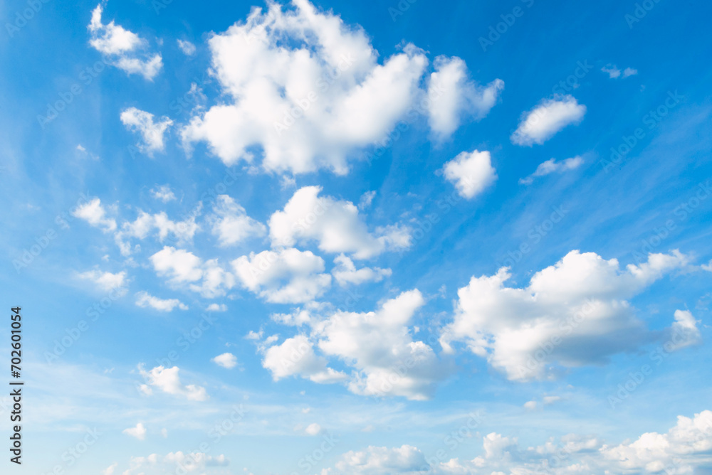 Fototapeta premium Blue sky with some clouds. View over the clouds light background