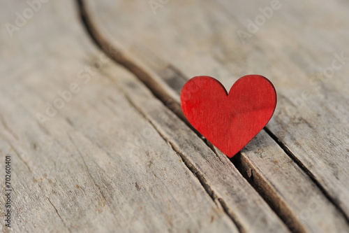 Valentines day card. Red heart on wooden background.