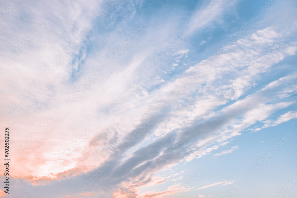 Obraz premium A beautiful sky tinted by the sun leaving vibrant shades of gold, pink, blue and multicolored. Clouds in the twilight evening and morning sky. Cloudy sky background in the evening and during the day.