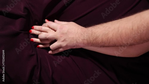 Lovers' hands squeeze each other in bed, romantic and passionate lovers make love. High quality FullHD footage