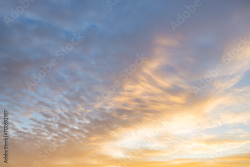 Fototapeta Naklejka Na Ścianę i Meble -  A beautiful sky tinted by the sun leaving vibrant shades of gold, pink, blue and multicolored. Clouds in the twilight evening and morning sky. Cloudy sky background in the evening and during the day.