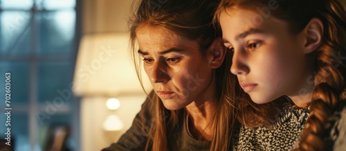 Mother morally supporting upset daughter in studies. photo