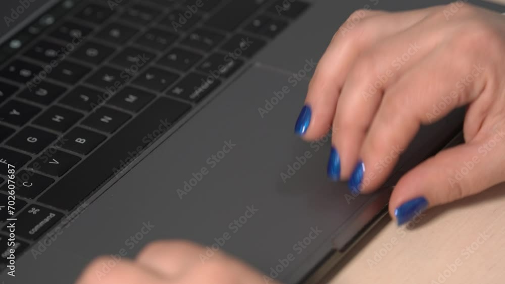 Female's fingers working with laptop . Female Hand using a laptop touch. Working from home or office, teleworking, telecommuting, or freelancing. Female's fingers working with laptop . Female Hand using a laptop touch. Working from home or office, teleworking, telecommuting, or freelancing.