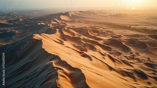 Aerial Photography, expansive view of the Arabian Desert, early morning, soft pastel light, rolling sand hills, soft pinks and light browns, serene desert morning.