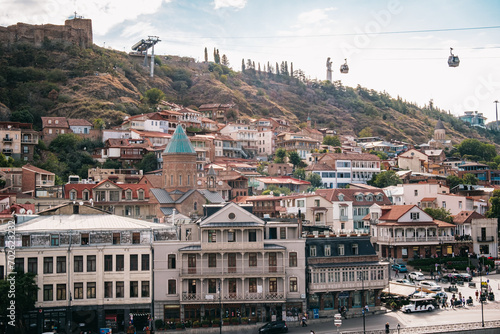 View on the Narikala fortress wall, the Tbilisi ropeway and the blue roof of the bell tower of Saint George's church in Kala, Tbilisi old town, Georgia