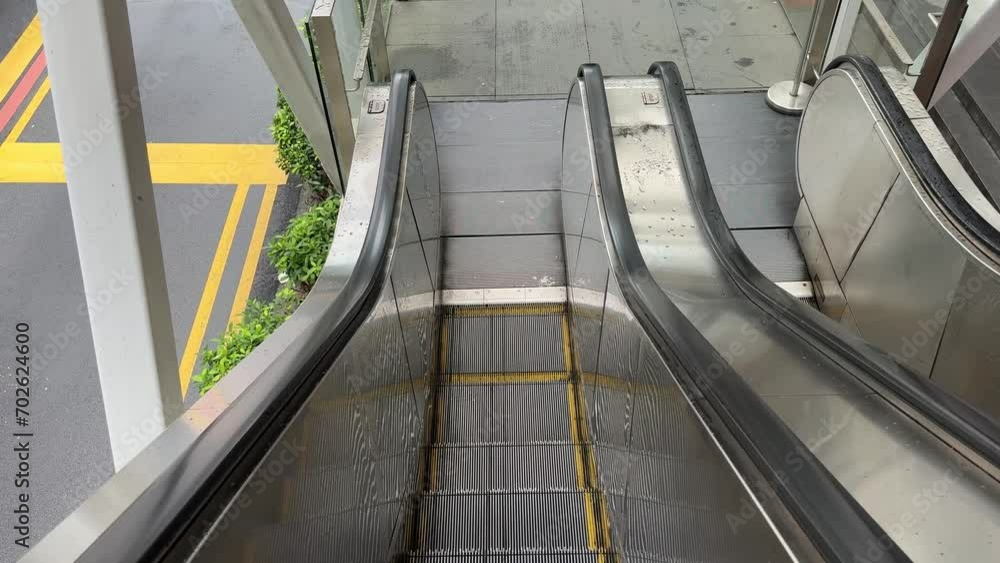 Point of View of  a  outdoor empty escalator going down. High-angle shot.