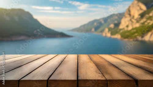 Wooden Table with Blurred Nature Background on a Peaceful Sunny Day by the Sea and Mountains, Providing Copy Space for Product Advertising © Tatiana