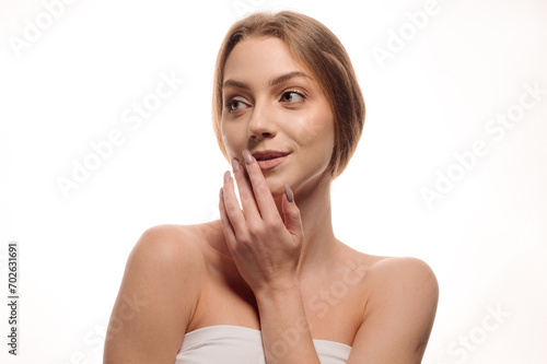 Beauty portrait of a blonde girl posing on an isolated white background. Skin care concept