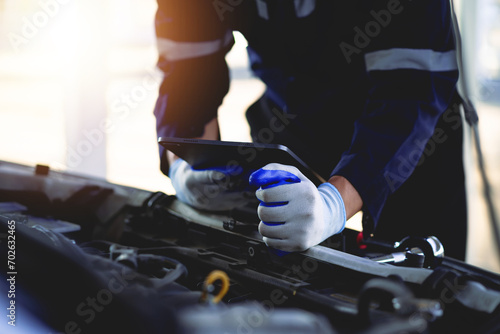 Auto mechanic is repairing a car in the garage. Check the safety of the car Engine in the garage Repair service concept.