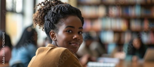Enthusiastic black woman learning at university, actively participating in class and eager for scholarships, striving for academic growth and success as a college student. photo