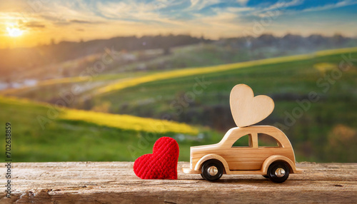 Valentine's day holiday celebration with a wooden toy car and heart shape, countryside
