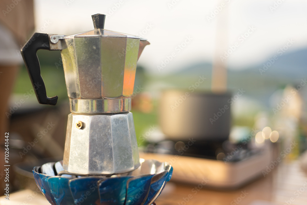 Food lover at Camping! Dripping coffee during camping at natural lake and mountain view background. Recreation and journey outdoor activity lifestyle. Food lover at Camping! Dripping coffee during camping at natural lake and mountain view background. Recreation and journey outdoor activity lifestyle.