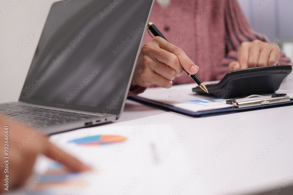 Two beautiful Asian employees enjoying successful work and confidently holding hands to work productively together at the office. Businessman, employee, African, laptop. Two beautiful Asian employees enjoying successful work and confidently holding hands to work productively together at the office. Businessman, employee, African, laptop.