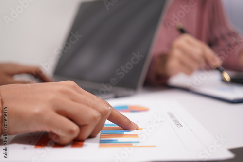 Fototapeta Naklejka Na Ścianę i Meble -  Two beautiful Asian employees enjoying successful work and confidently holding hands to work productively together at the office. Businessman, employee, African, laptop.