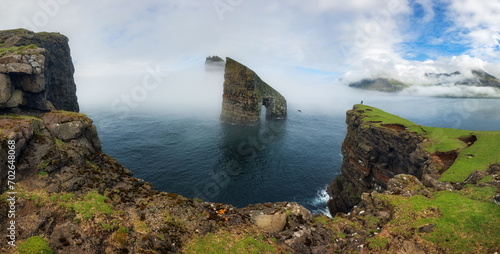 The beautiful Drangarnir Arch on the Faroe Islands, Atlantic ocean landscape with cliff