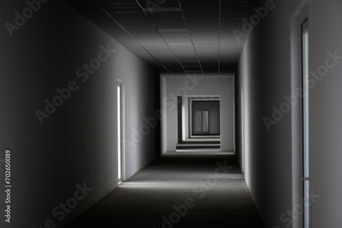 Fototapeta Naklejka Na Ścianę i Meble -  Empty corridor with light from the window. A light in the end of a tunnel