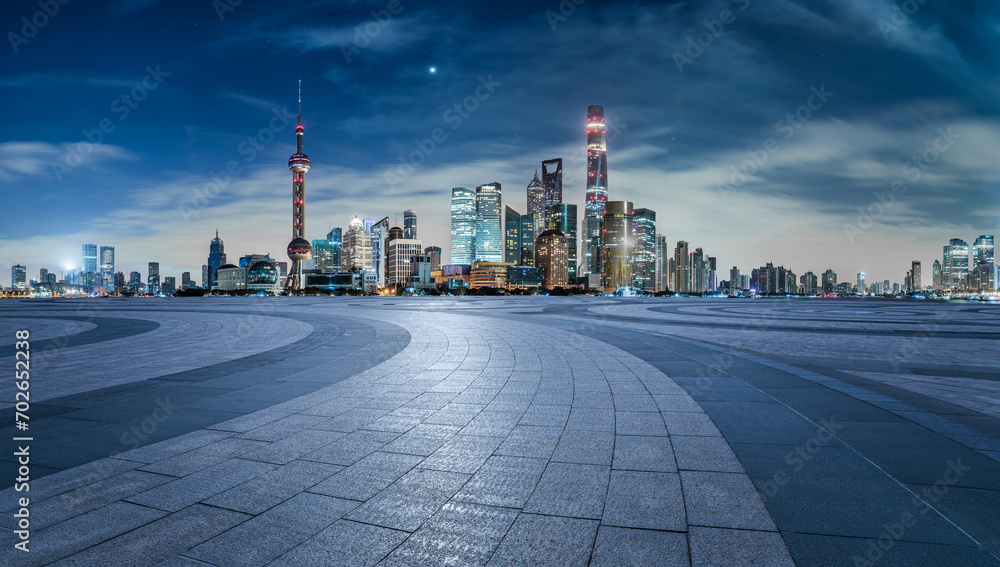 Empty square floor and modern city building scenery at night in Shanghai