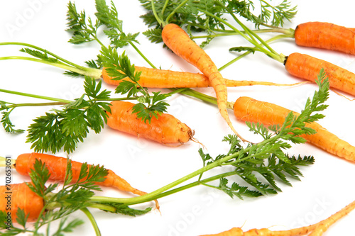 Organic mini carrots isolated on white background
