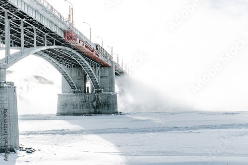 Bridge is over frozen river. Embankment of the Ob river in winter in Novosibirsk frost day -40 degrees Celsius
