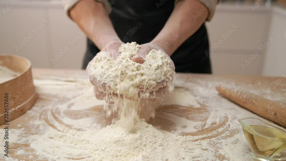 A cook in the kitchen sifts flour through a sieve. Kneading raw dough with male hands. Breaks an egg. White flour. A cook in the kitchen sifts flour through a sieve. Kneading raw dough with male hands. Breaks an egg. White flour.