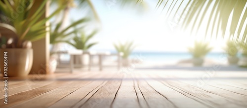 White sand beachside wooden terrace Blur tropical beach  bokeh sun and palm trees in coffee photo room