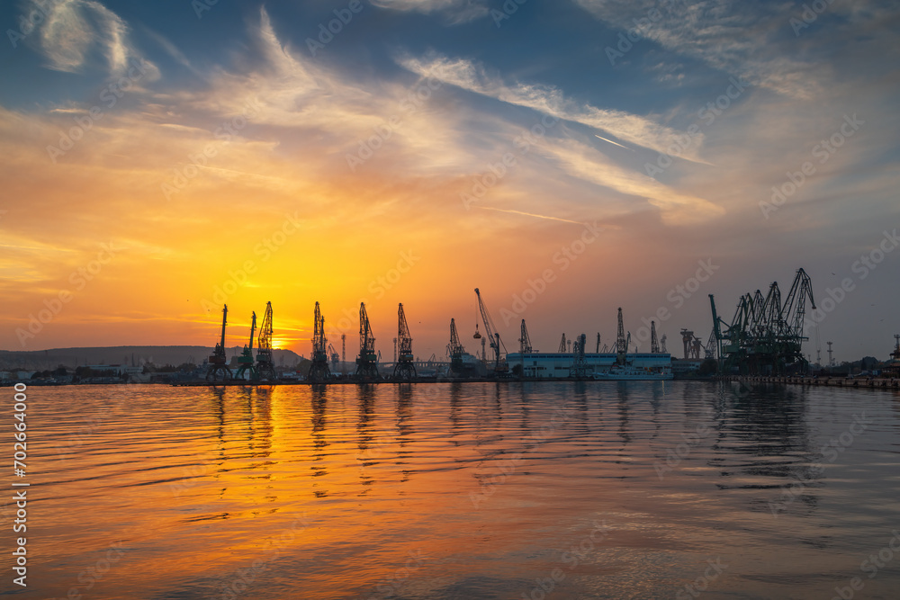 Sunset over sea port and industrial cranes seascape, Varna Bulgaria