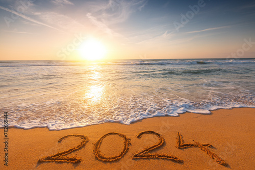 Fototapeta Naklejka Na Ścianę i Meble -  2024 Year Number Handwritten On A Sandy Tropical Beach Scenic Sunrise nature Landscape