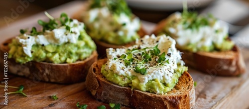 Grilled or toasted bread with cream cheese and avocado spread. photo