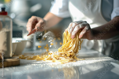 Close up hands of a chef making homemade pasta in background of modern kitchen. Cooking concept of food and homemade, photo