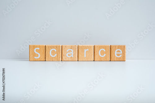 Tableau sur toile Wooden blocks form the text Scarce against a white background.