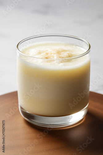 Eggnog or egg milk punch is traditional drink in Christmas season on white background