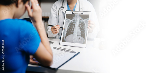  Female doctor filling up an application form while consulting patient. Medicine and health care concept. to meet patients after x-ray