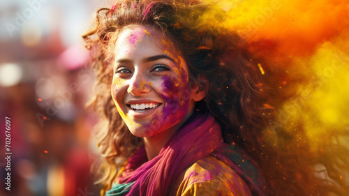 A girl in the India dress is enjoying colorful powder. Holi festival photo