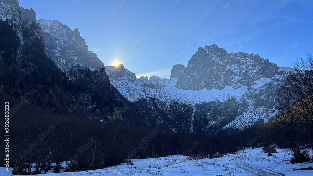 Mountain, snowy peaks against the blue sky