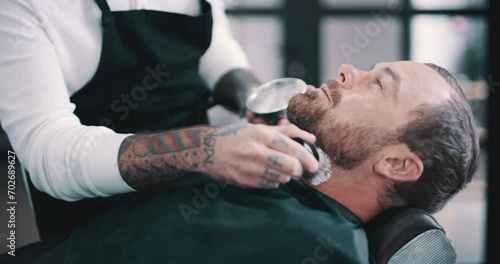 Barbershop people, beard cream and client cut for facial grooming, maintenance or hairdressing treatment. Hairdresser equipment, customer and barber hands with brush for shaving creme application photo