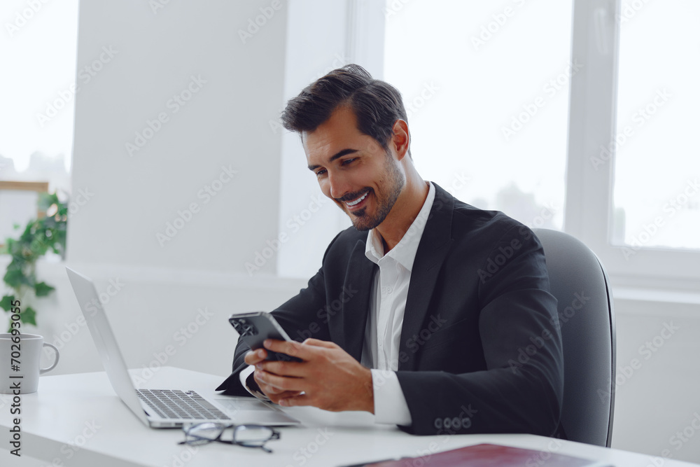 Man in office businessman sitting at desk and working in laptop and talking on phone, modern suit, finance and startup concept and data analysis, working lifestyle in bright office. Man in office businessman sitting at desk and working in laptop and talking on phone, modern suit, finance and startup concept and data analysis, working lifestyle in bright office.
