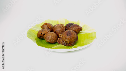 Kuzhi Paniyaram, These golden brown dumplings are made from a fermented batter of rice and urad dal, giving them a unique flavor and texture.