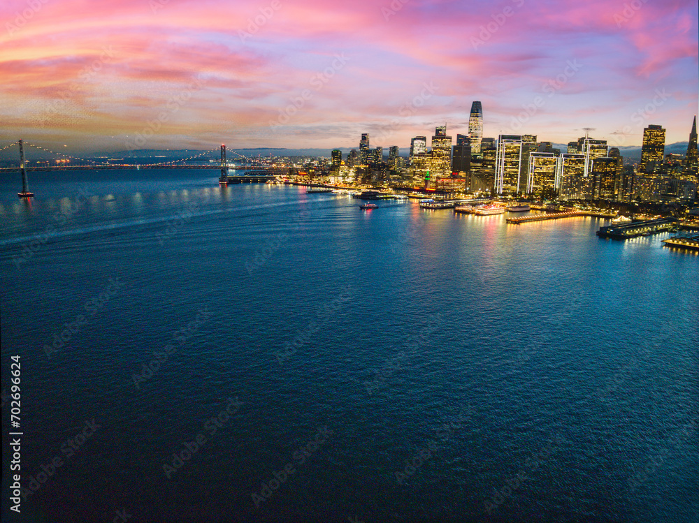 Aerial view of San Francisco city skyline at sunset, illuminated by the city lights
