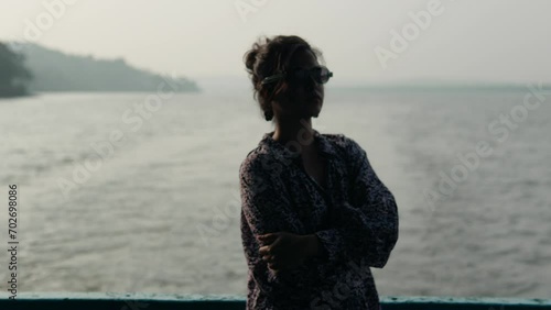 Silhouette of Unrecognizable Young Woman Sailing on Indian River. photo