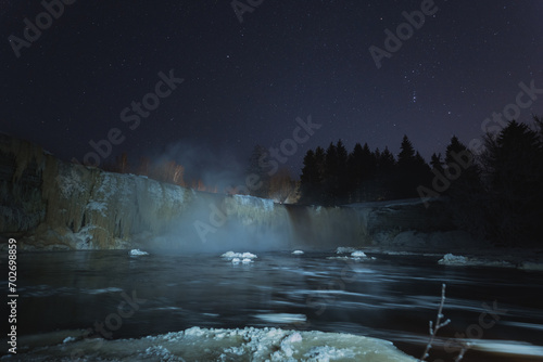 Jagala waterfall at night in winter, low light photography. photo